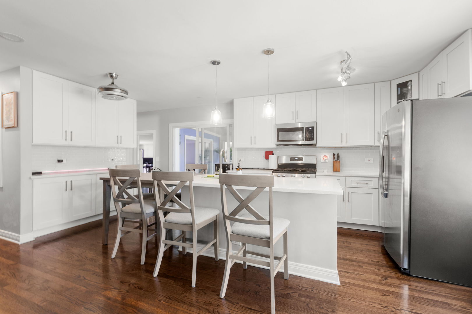 1013 Longaker Road Northbrook, IL 60062 - Photo 4 of 30 a kitchen with stainless steel appliances a table chairs refrigerator sink and cabinets