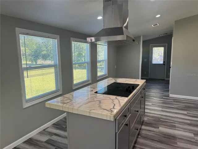 a kitchen with a stove and a kitchen island