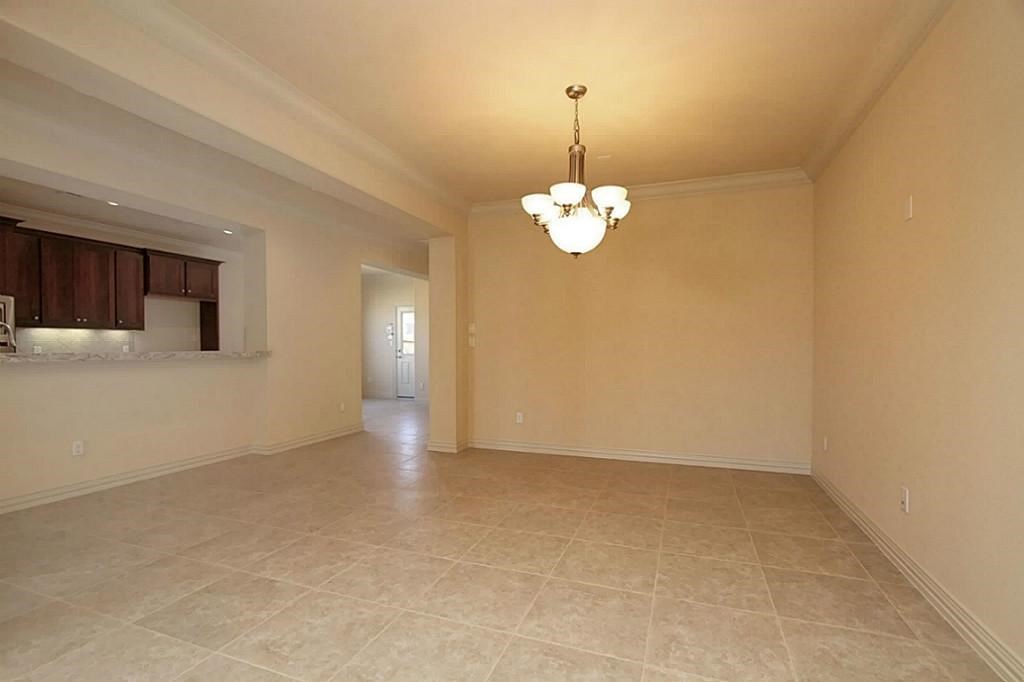 14478 Summerleaf Lane Houston, TX 77077 - Photo 11 of 26 a view of empty room with a chandelier fan and kitchen view