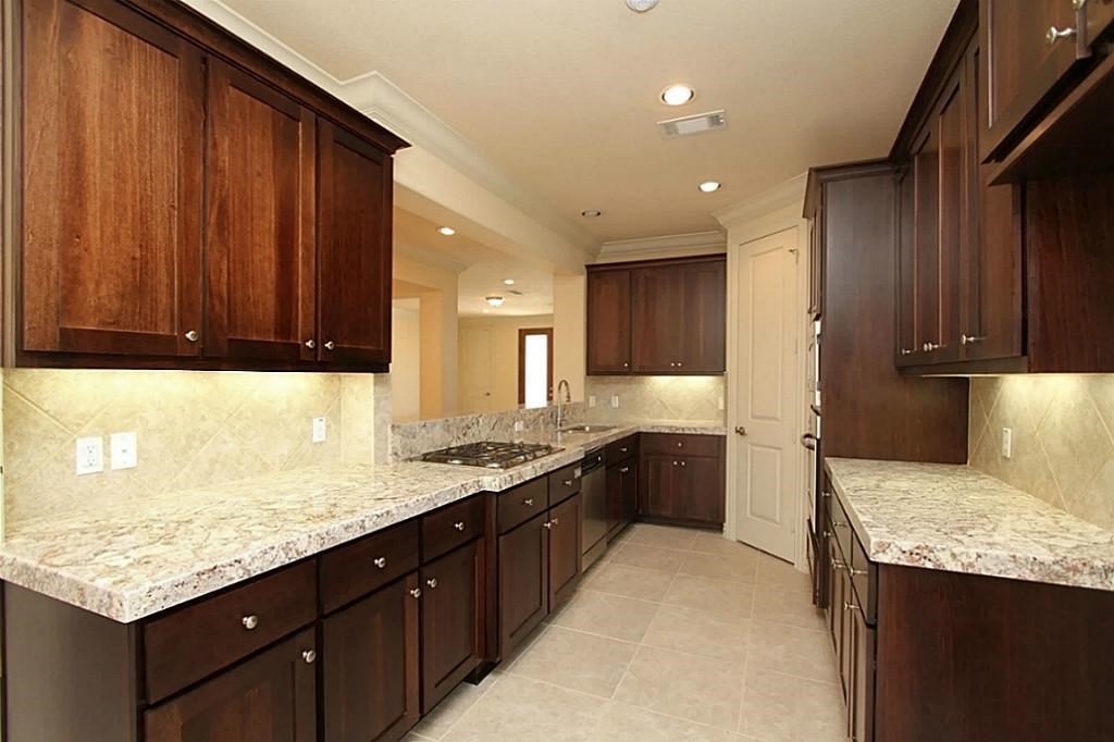 14478 Summerleaf Lane Houston, TX 77077 - Photo 8 of 26 a kitchen with a sink dishwasher a stove and a refrigerator with wooden cabinets
