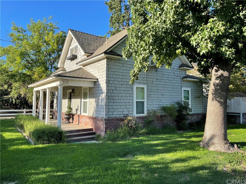 9596 Golf Link Road Delhi, CA 95315 - Photo 1 of 1 a front view of a house with a yard and porch