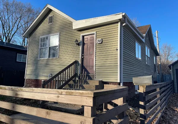a view of house with a deck and furniture