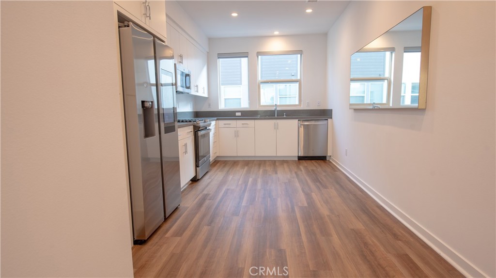 339 Placemark Irvine, CA 92614 - Photo 18 of 30 a view of kitchen with wooden floor and electronic appliances