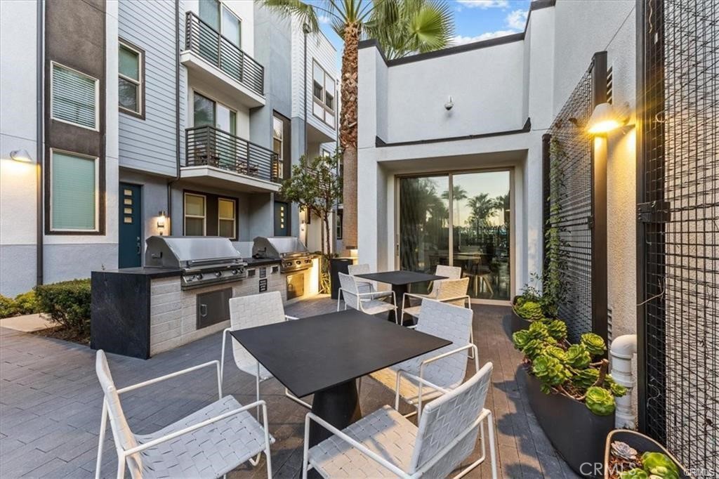 339 Placemark Irvine, CA 92614 - Photo 25 of 30 a view of a dinning tables and chairs in a patio