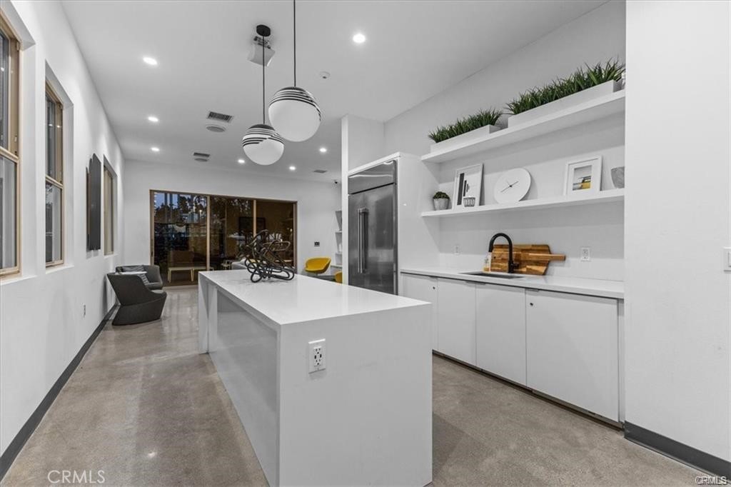 339 Placemark Irvine, CA 92614 - Photo 28 of 30 a large white kitchen with lots of counter space and a sink