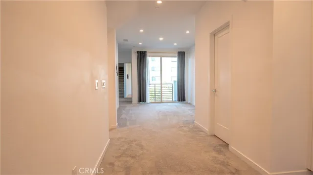 a view of hallway with windows