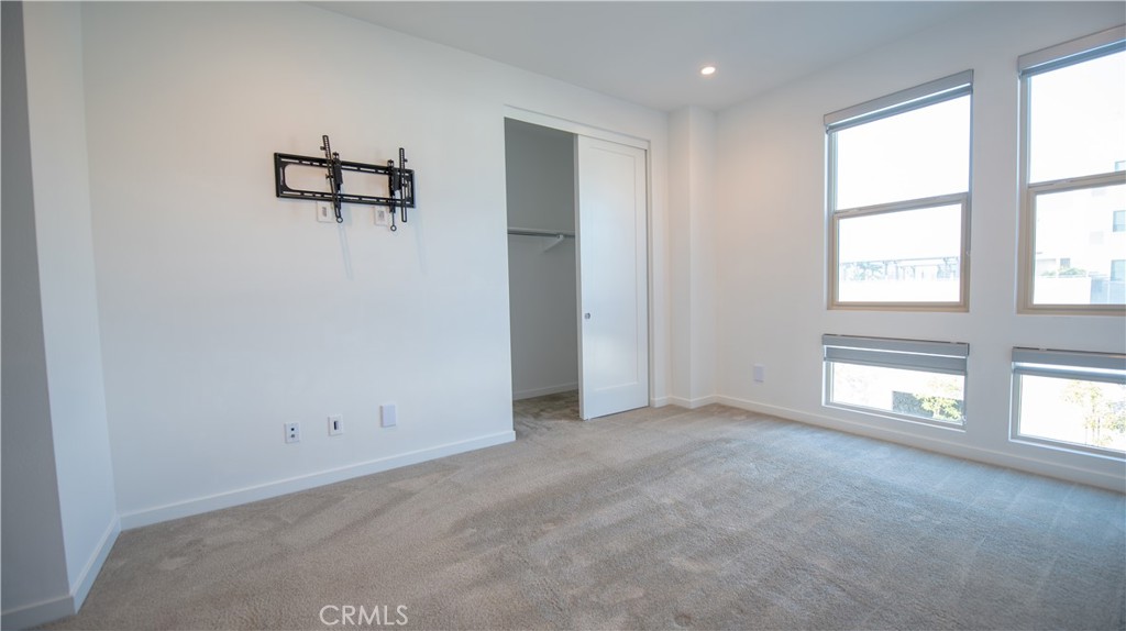 339 Placemark Irvine, CA 92614 - Photo 10 of 30 an empty room with windows and ceiling fan