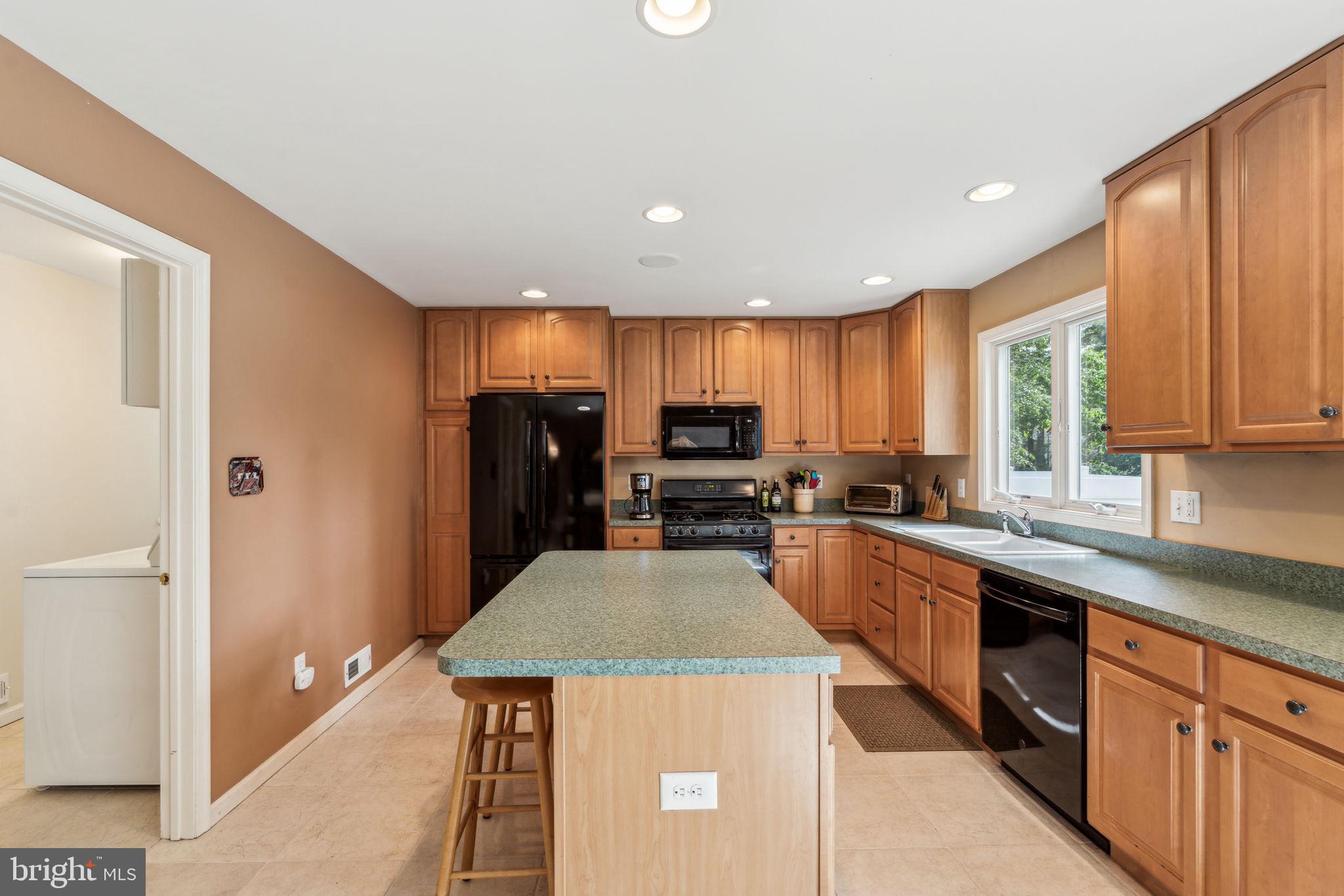 22 Devonshire Drive Voorhees, NJ 08043 - Photo 22 of 54 a kitchen with kitchen island granite countertop stainless steel appliances a sink a stove a refrigerator cabinets and a window