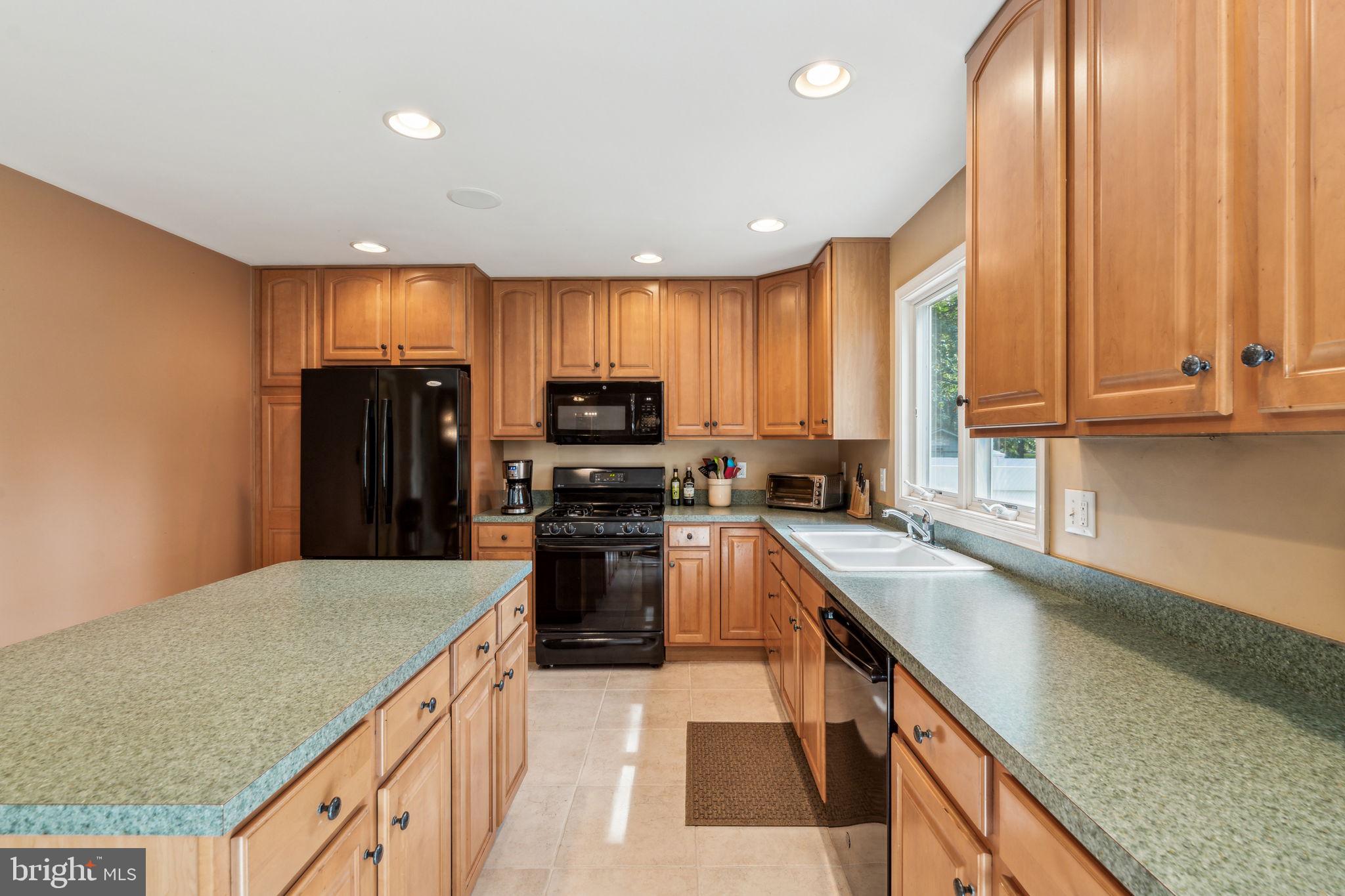 22 Devonshire Drive Voorhees, NJ 08043 - Photo 24 of 54 a kitchen with stainless steel appliances granite countertop a sink a stove and a refrigerator