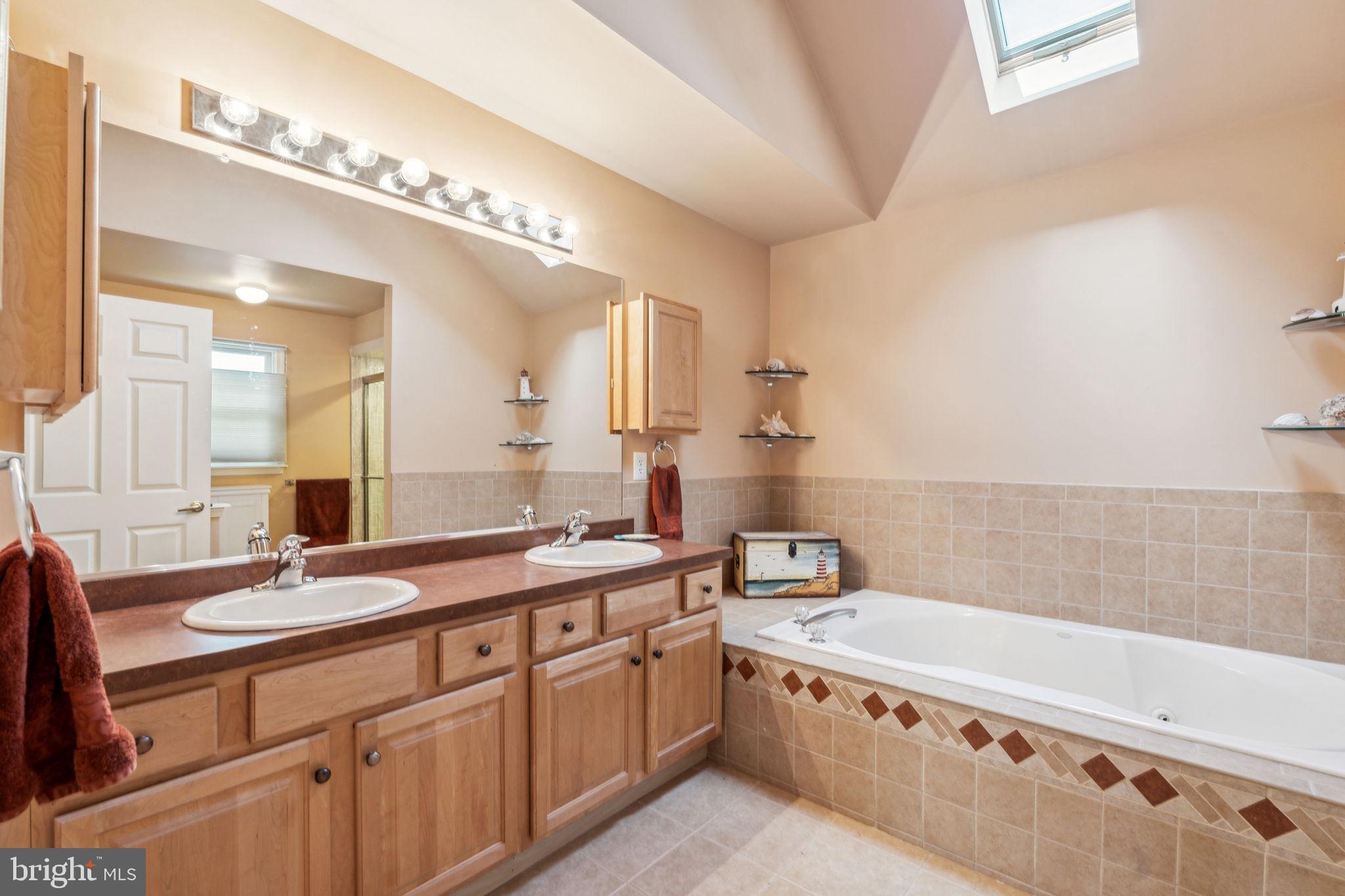 22 Devonshire Drive Voorhees, NJ 08043 - Photo 32 of 54 a spacious bathroom with a granite countertop sink a large mirror and bathtub