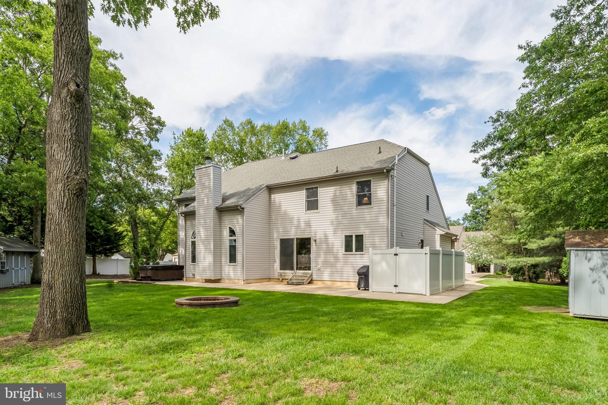 22 Devonshire Drive Voorhees, NJ 08043 - Photo 49 of 54 a view of a white house with a big yard and large tree