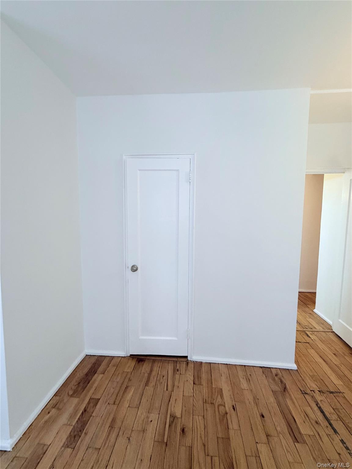 99-21 67th Road, Unit 3A Queens, NY 11375 - Photo 14 of 18 hallway closet with hardwood / wood-style floors and baseboards