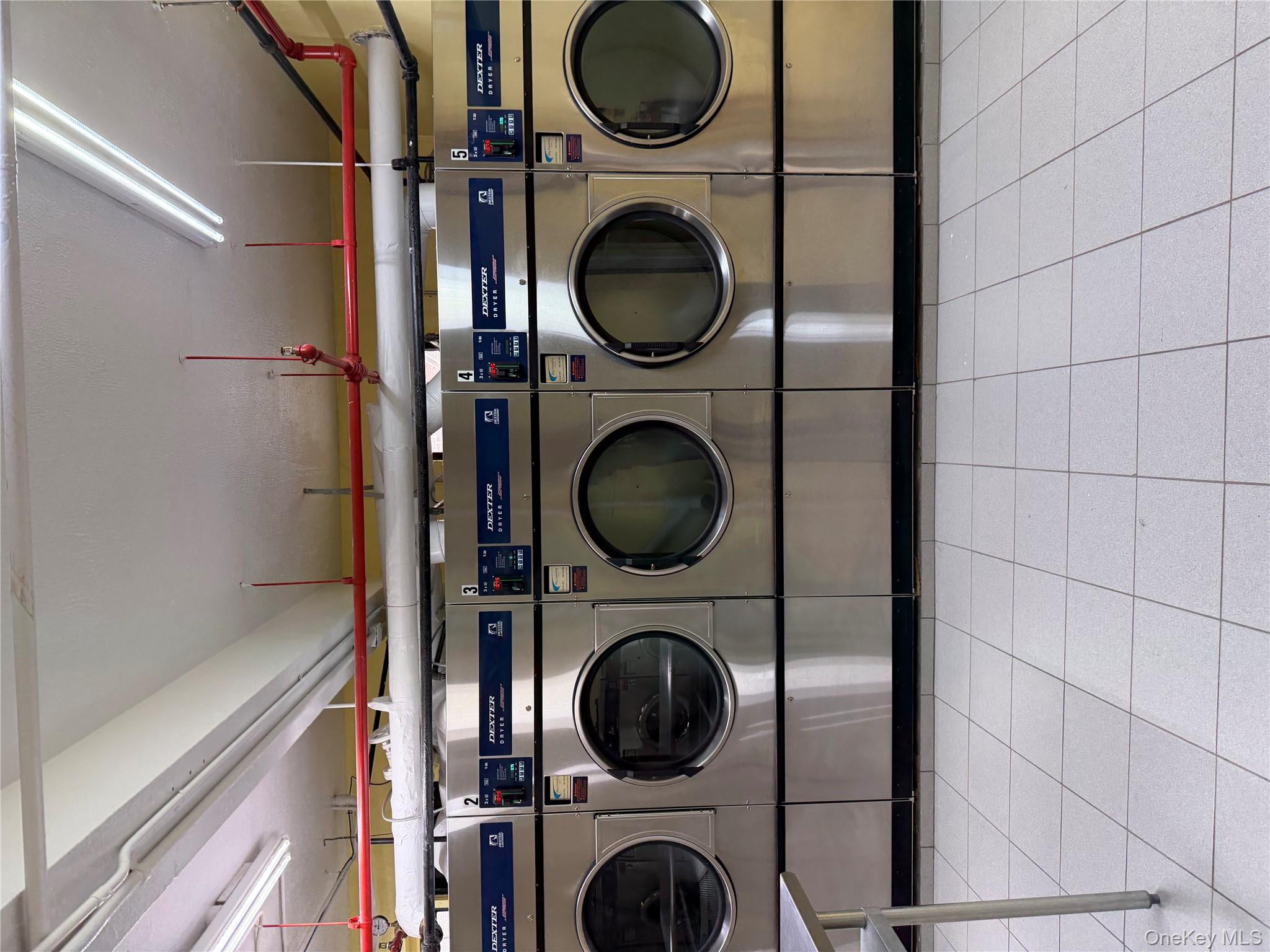 99-21 67th Road, Unit 3A Queens, NY 11375 - Photo 16 of 18 Community laundry featuring washing machine and dryer