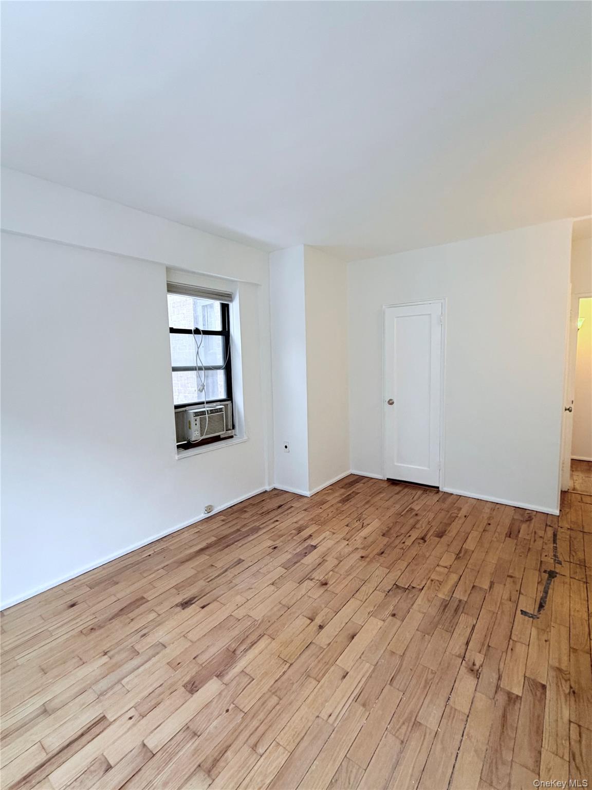 99-21 67th Road, Unit 3A Queens, NY 11375 - Photo 16 of 22 a view of empty room with wooden floor and fan