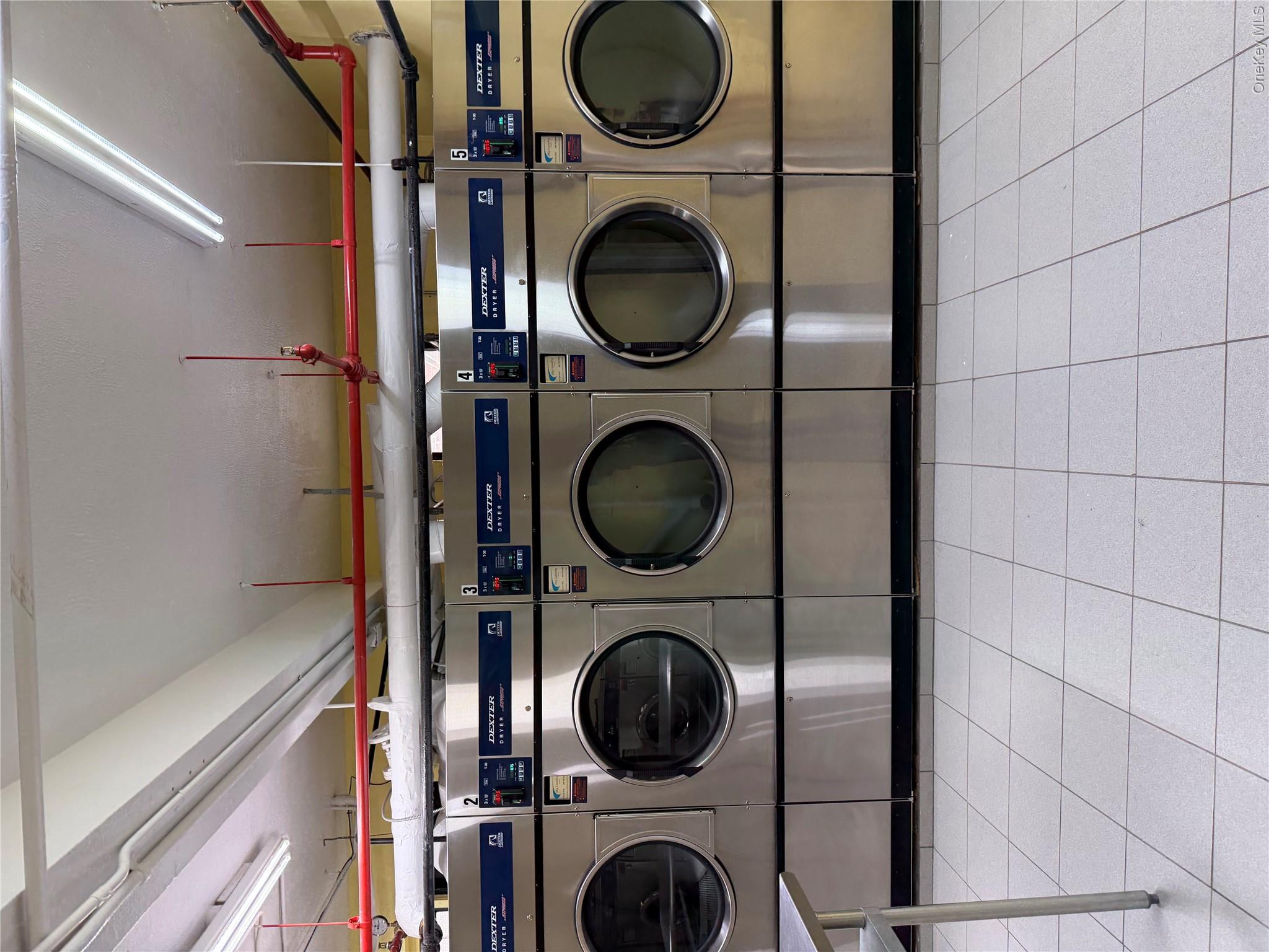 99-21 67th Road, Unit 3A Queens, NY 11375 - Photo 20 of 22 a utility room with dryer and washer