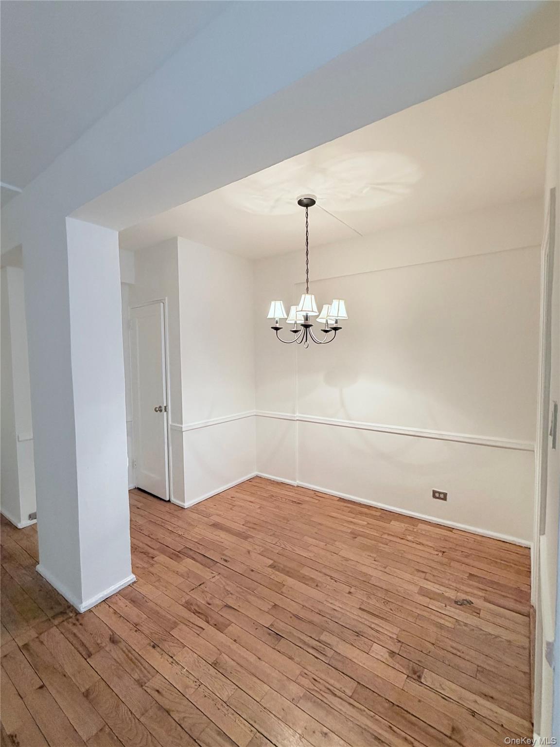 99-21 67th Road, Unit 3A Queens, NY 11375 - Photo 2 of 18 Dining room featuring light wood-type flooring and suspended lighting
