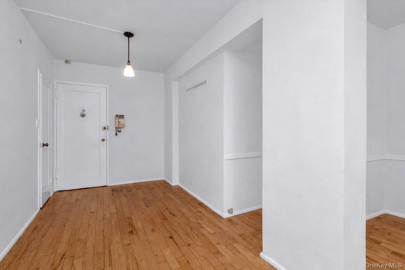 99-21 67th Road, Unit 3A Queens, NY 11375 - Photo 3 of 18 Foyer featuring light wood-style floors and baseboards