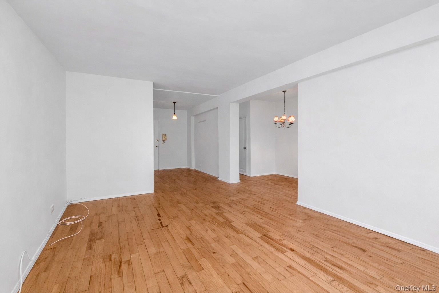 99-21 67th Road, Unit 3A Queens, NY 11375 - Photo 4 of 18 light wood-style floors and suspended lighting