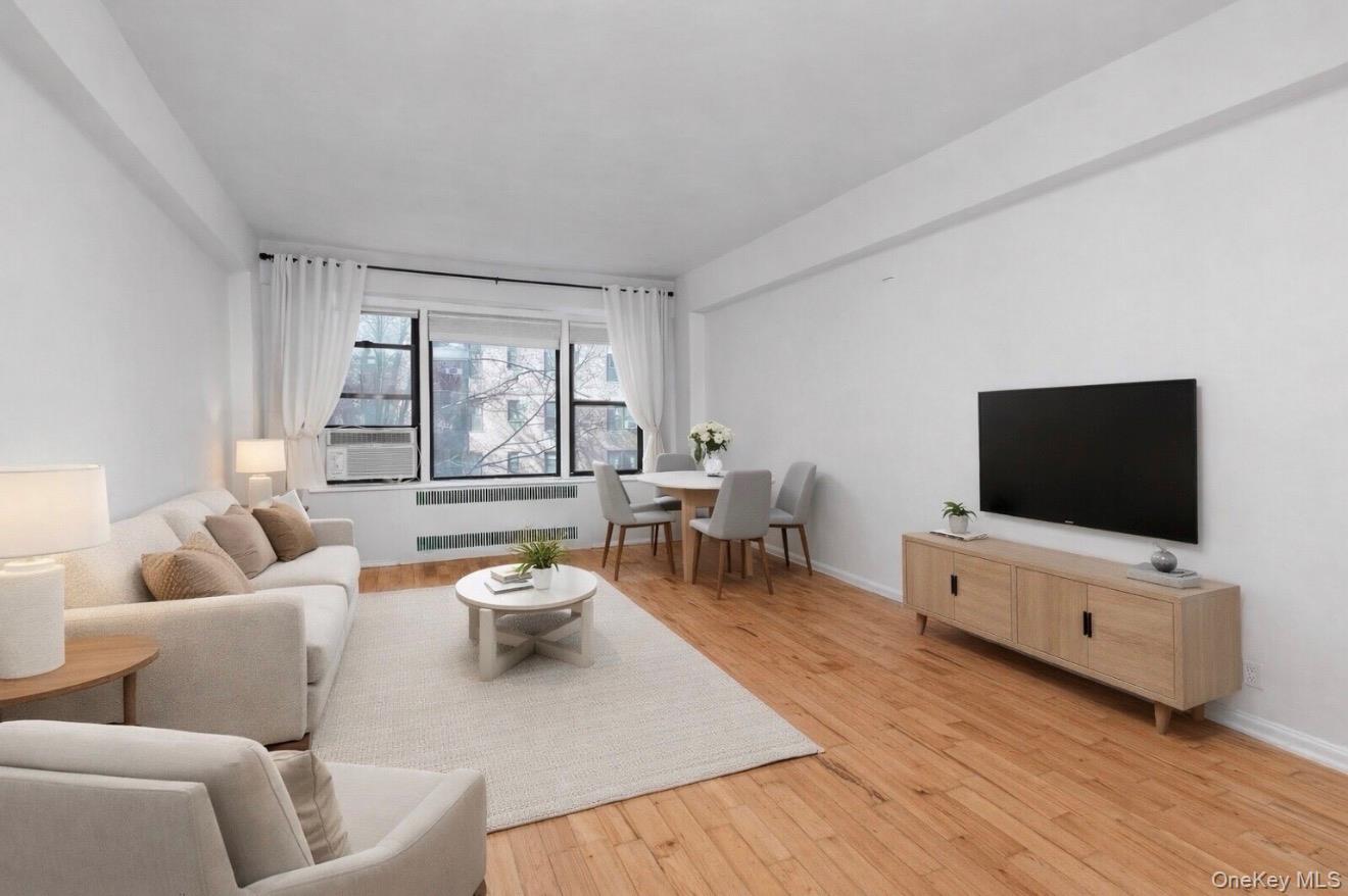 99-21 67th Road, Unit 3A Queens, NY 11375 - Photo 9 of 22 a living room with furniture and a flat screen tv