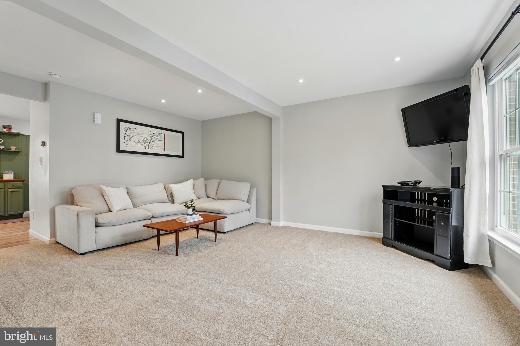 7045 Sauvage Lane Gainesville, VA 20155 - Photo 11 of 43 a living room with furniture and a flat screen tv