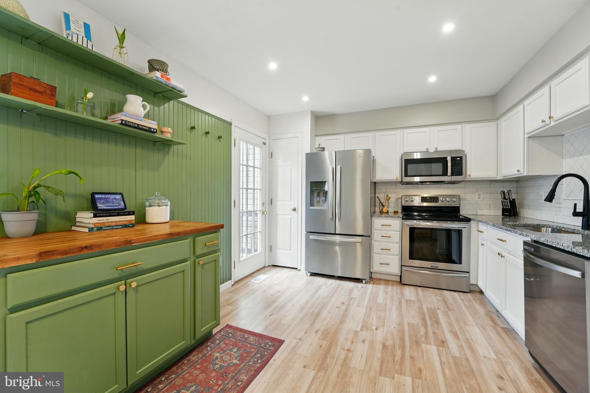 7045 Sauvage Lane Gainesville, VA 20155 - Photo 16 of 43 a kitchen with a sink stainless steel appliances and cabinets