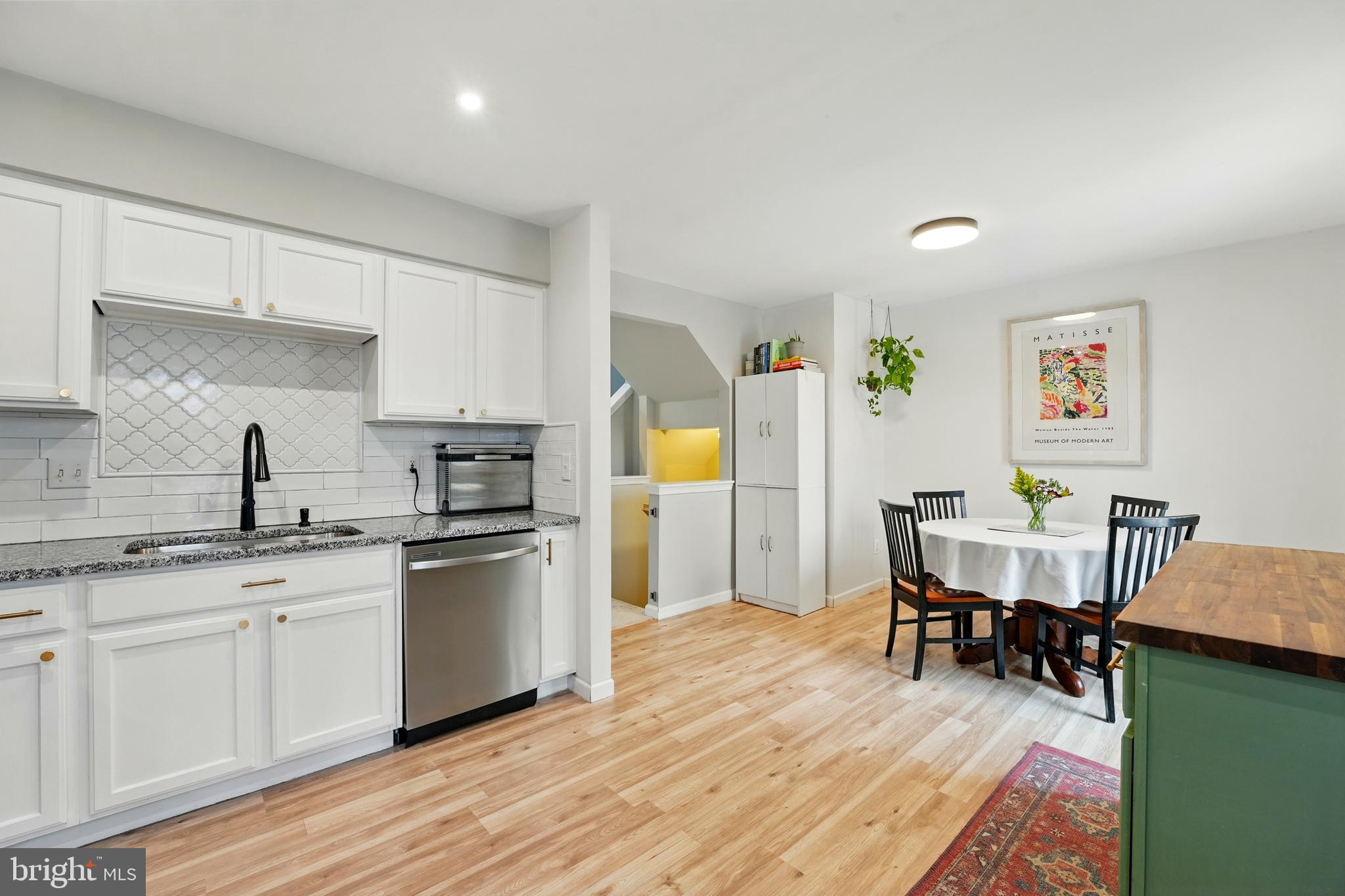 7045 Sauvage Lane Gainesville, VA 20155 - Photo 19 of 43 a kitchen with a sink cabinets and wooden floor