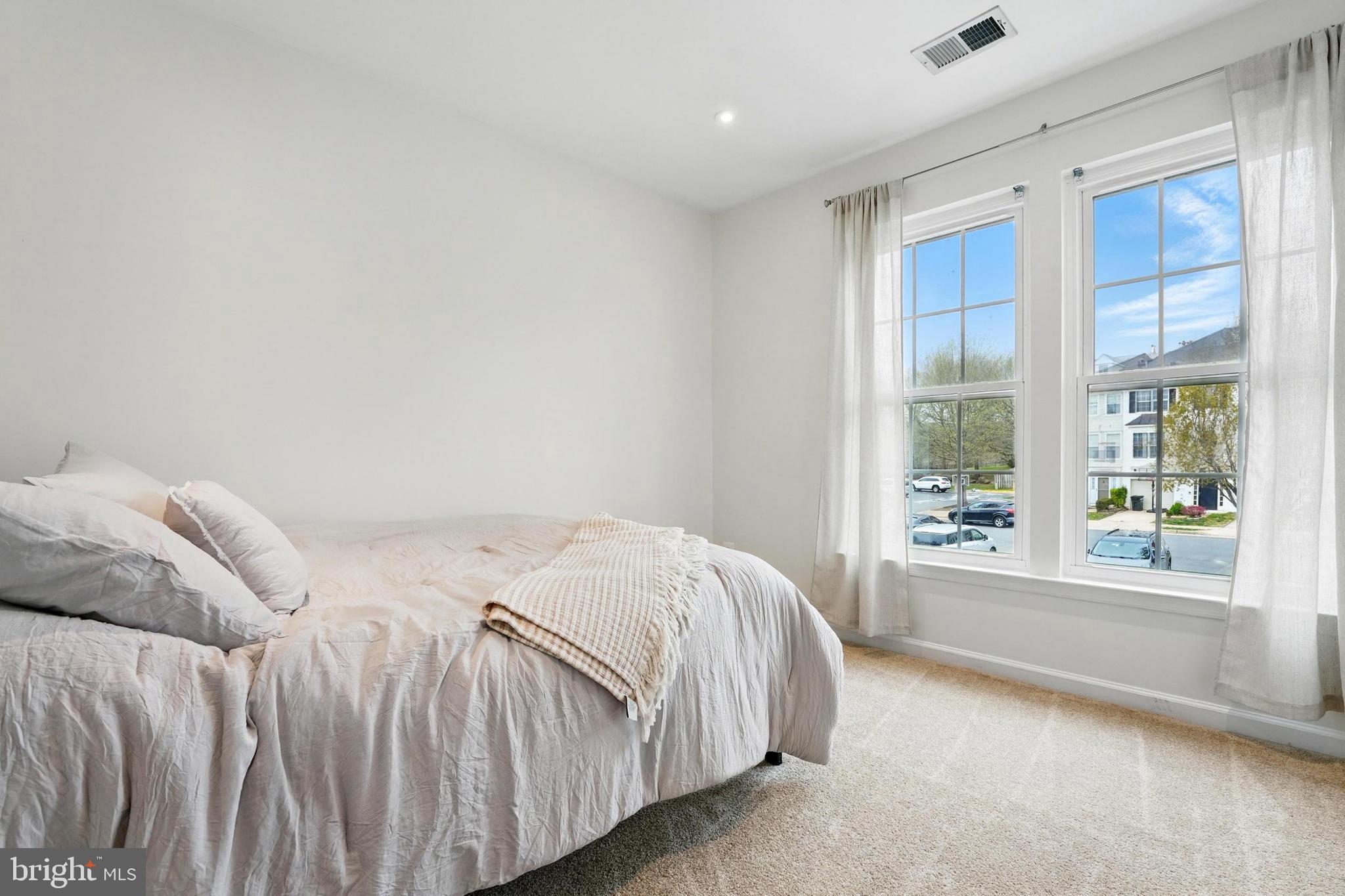 7045 Sauvage Lane Gainesville, VA 20155 - Photo 24 of 43 a bedroom with a bed and a large window
