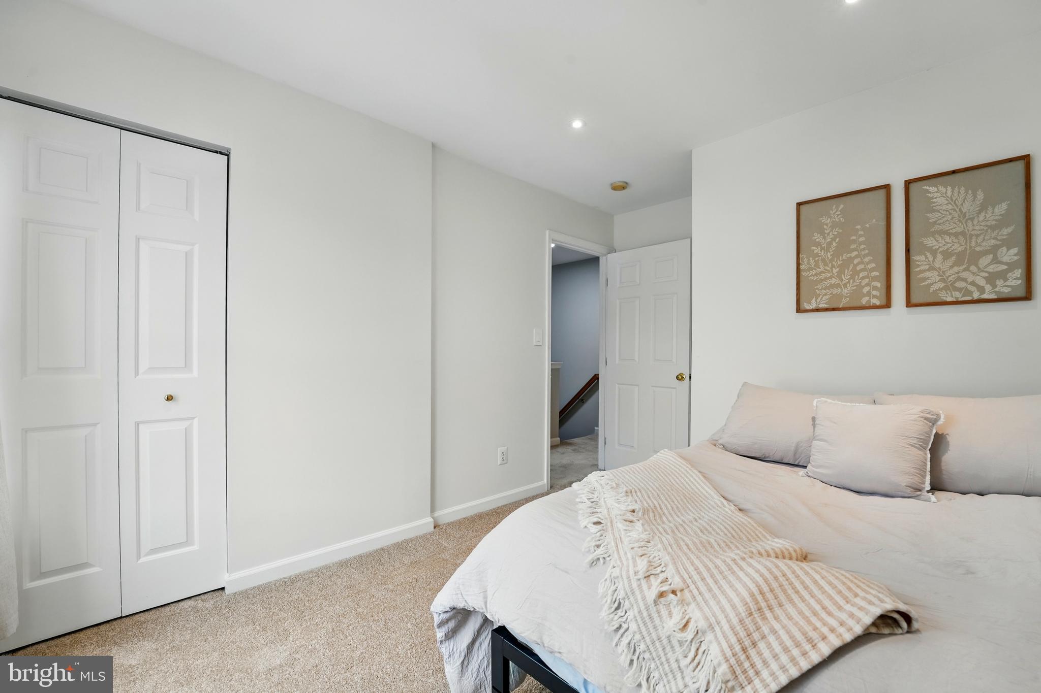 7045 Sauvage Lane Gainesville, VA 20155 - Photo 25 of 43 a bedroom with a bed and a painting on the wall