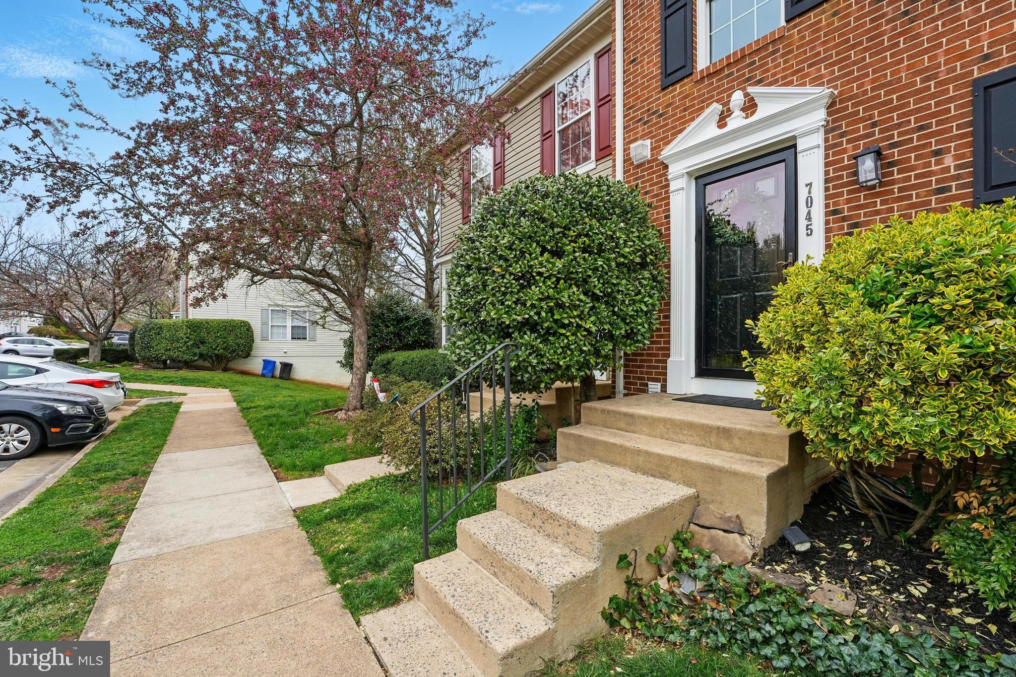 7045 Sauvage Lane Gainesville, VA 20155 - Photo 3 of 43 a front view of a house with a yard and trees