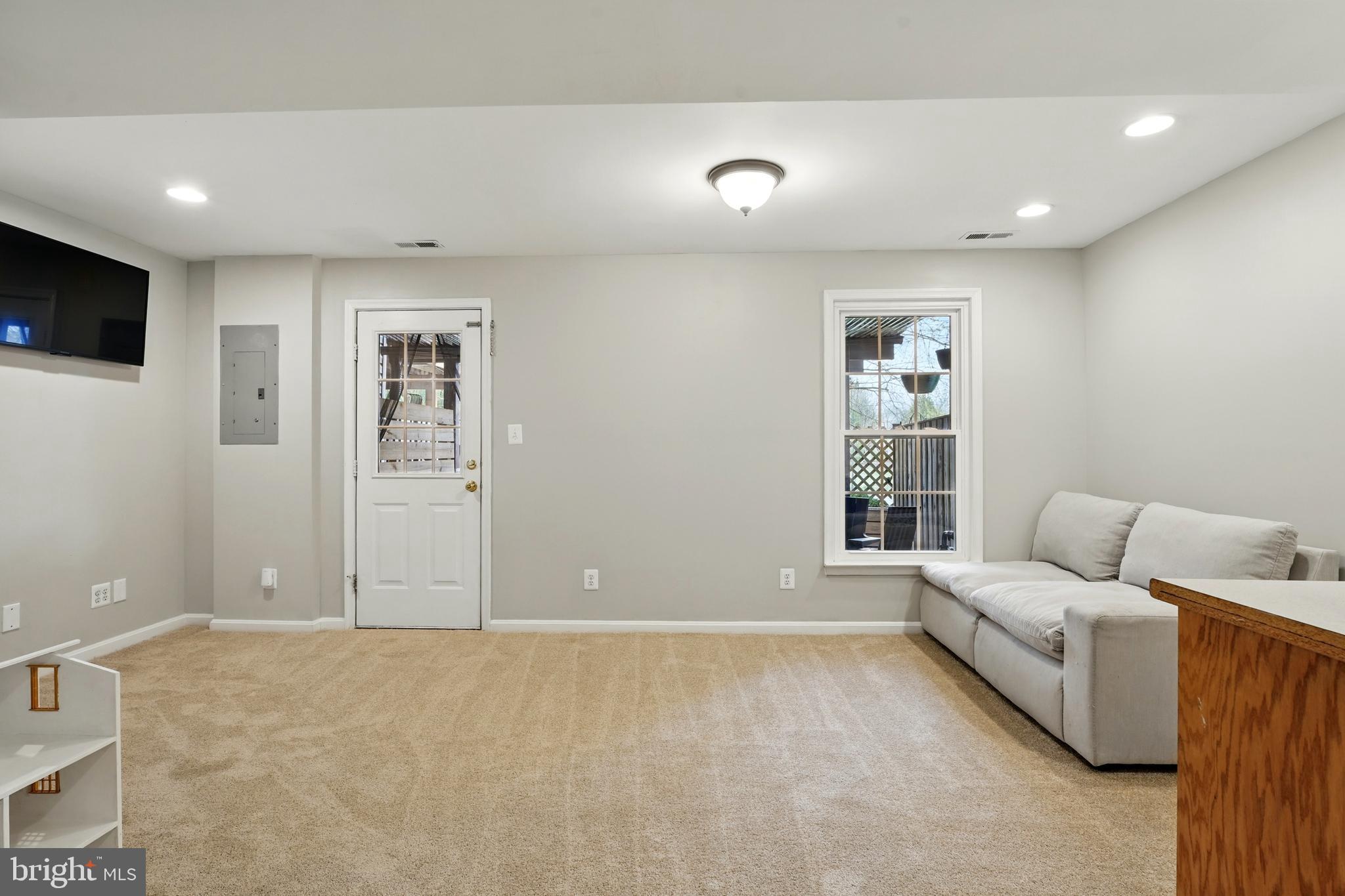 7045 Sauvage Lane Gainesville, VA 20155 - Photo 33 of 43 a living room with furniture and a window