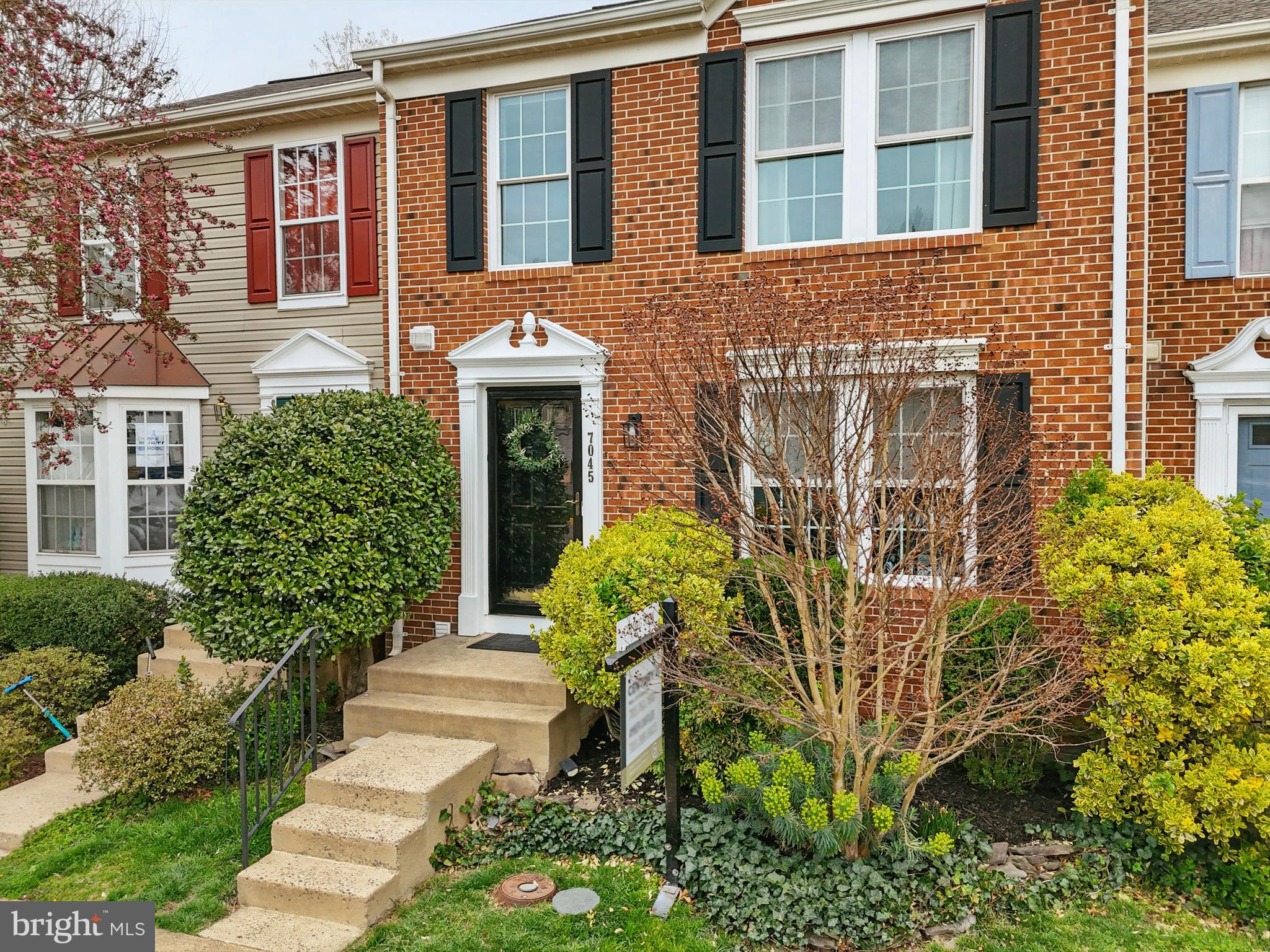 7045 Sauvage Lane Gainesville, VA 20155 - Photo 4 of 43 a front view of a house with a garden