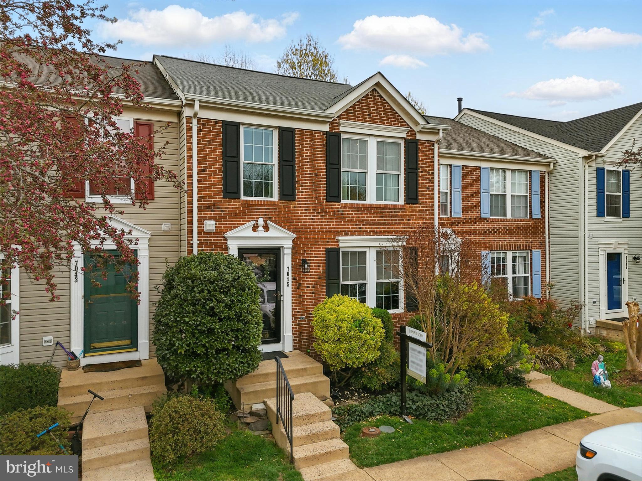 7045 Sauvage Lane Gainesville, VA 20155 - Photo 6 of 43 front view of house with a yard and potted plants
