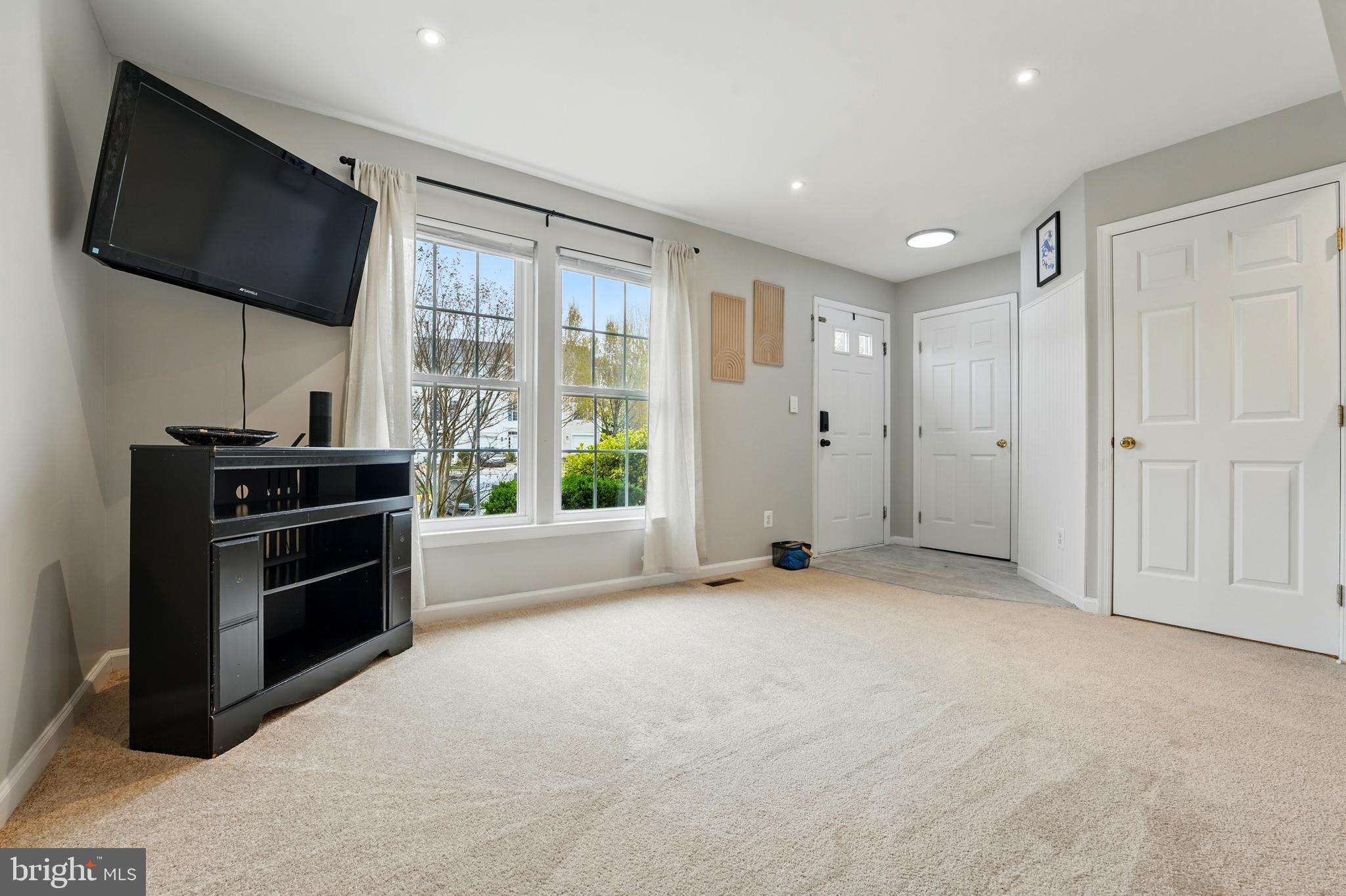 7045 Sauvage Lane Gainesville, VA 20155 - Photo 9 of 43 a view of an empty room with a flat screen tv and outdoor view