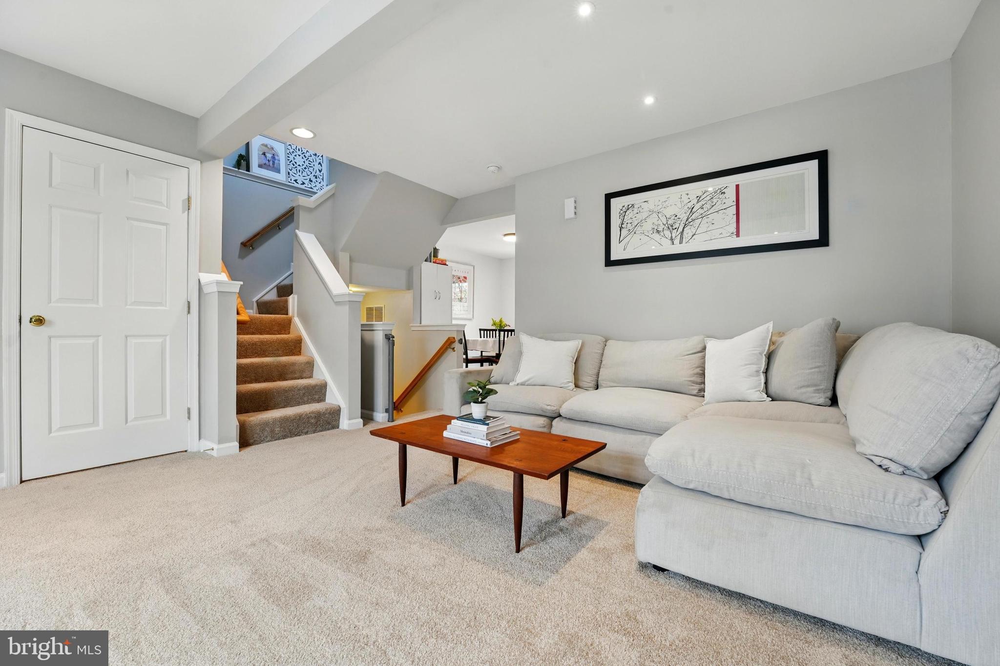 7045 Sauvage Lane Gainesville, VA 20155 - Photo 10 of 43 a living room with furniture and stairs with wooden floor