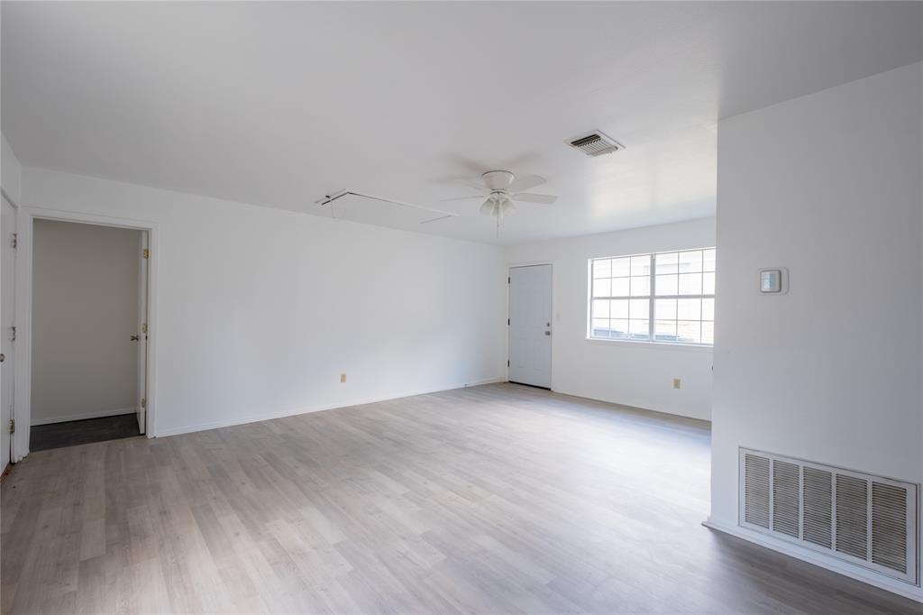 3126 Colgate Avenue Tyler, TX 75701 - Photo 26 of 33 an empty room with wooden floor and windows