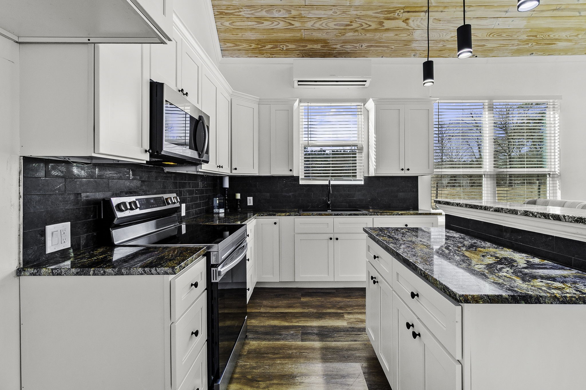 500 Highway 156 Point Blank, TX 77364 - Photo 41 of 50 a kitchen with stainless steel appliances granite countertop a stove and a microwave