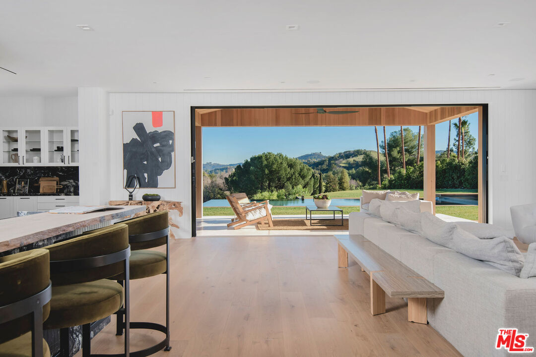 5505 Hoback Glen Road Hidden Hills, CA 91302 - Photo 14 of 43 a living room with stainless steel appliances kitchen island furniture and a large window