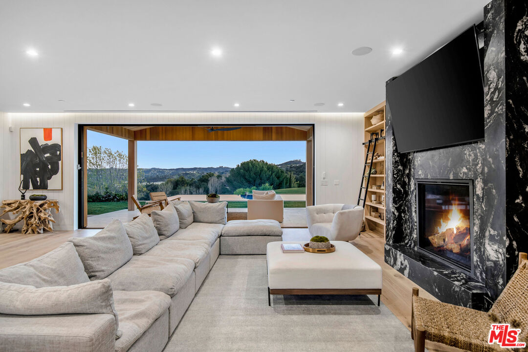 5505 Hoback Glen Road Hidden Hills, CA 91302 - Photo 15 of 43 a living room with furniture a flat screen tv and a fireplace