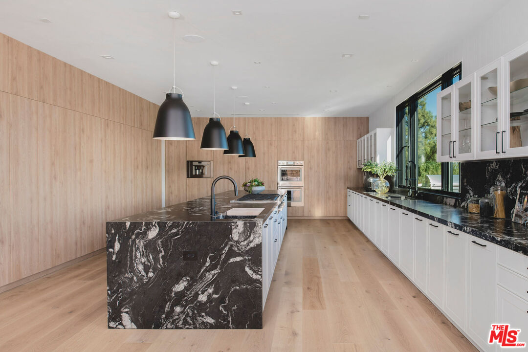 5505 Hoback Glen Road Hidden Hills, CA 91302 - Photo 16 of 43 a living room with furniture a large window and wooden floor