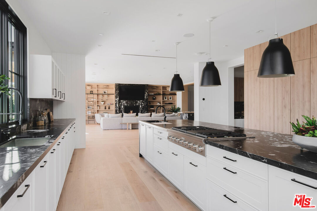 5505 Hoback Glen Road Hidden Hills, CA 91302 - Photo 18 of 43 a large kitchen with stainless steel appliances a stove a sink a microwave a refrigerator and cabinets