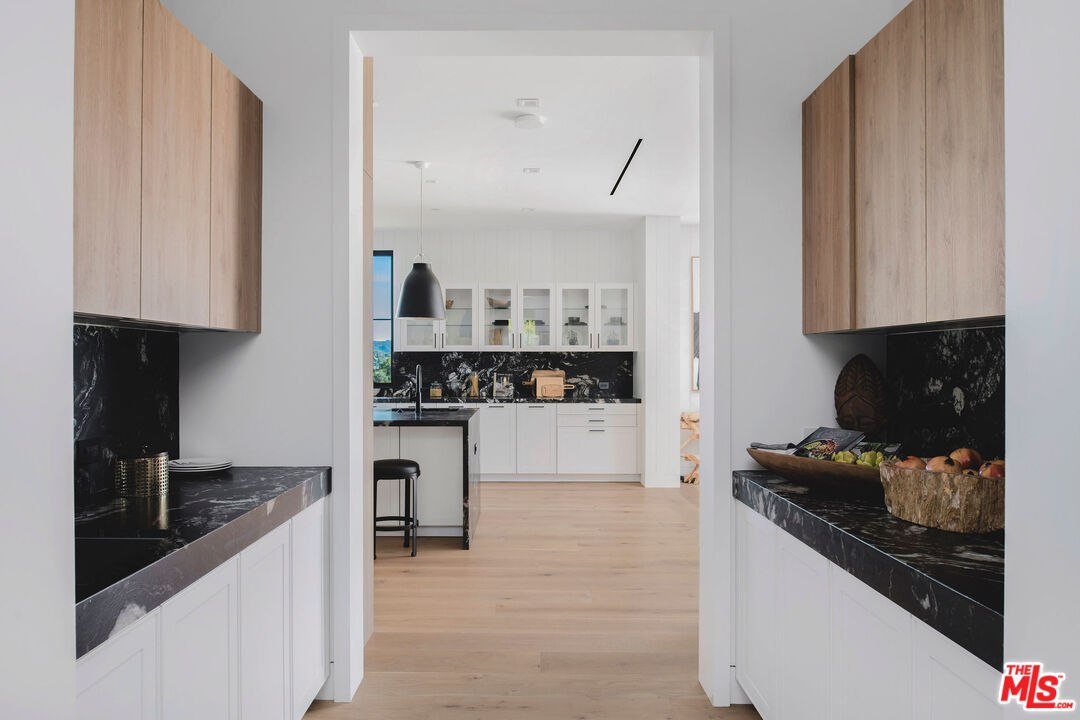 5505 Hoback Glen Road Hidden Hills, CA 91302 - Photo 20 of 43 a kitchen with white cabinets and appliances