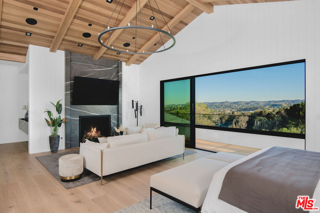 5505 Hoback Glen Road Hidden Hills, CA 91302 - Photo 25 of 43 a living room with furniture a fireplace and a flat screen tv