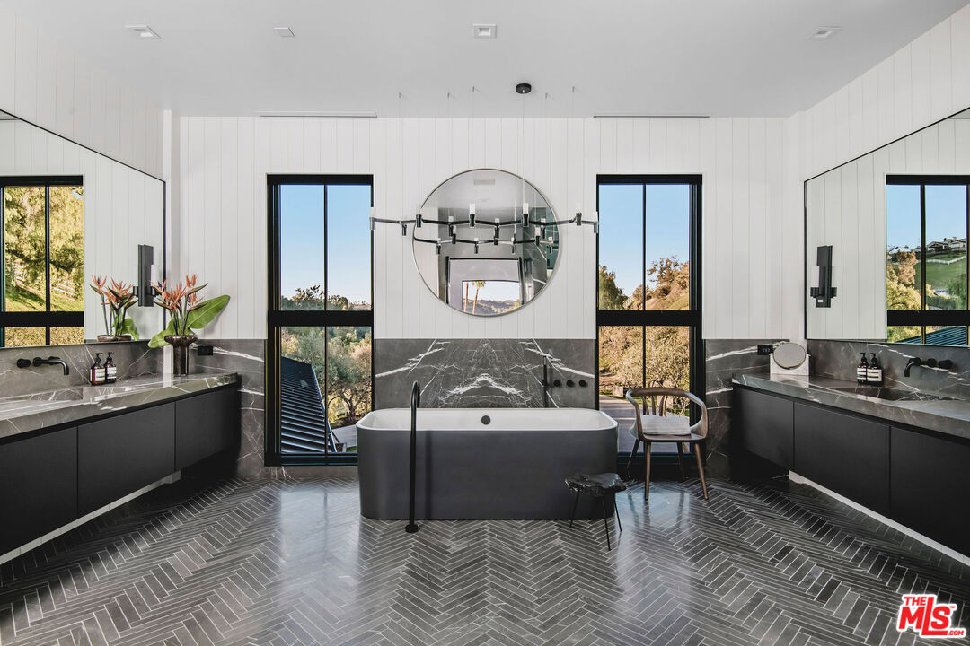 5505 Hoback Glen Road Hidden Hills, CA 91302 - Photo 27 of 43 a living room with furniture a rug and white walls