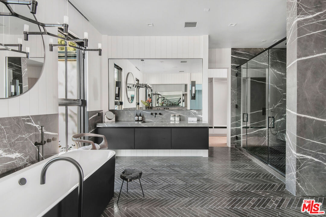 5505 Hoback Glen Road Hidden Hills, CA 91302 - Photo 28 of 43 a bathroom with a double vanity sink a mirror and a bathtub