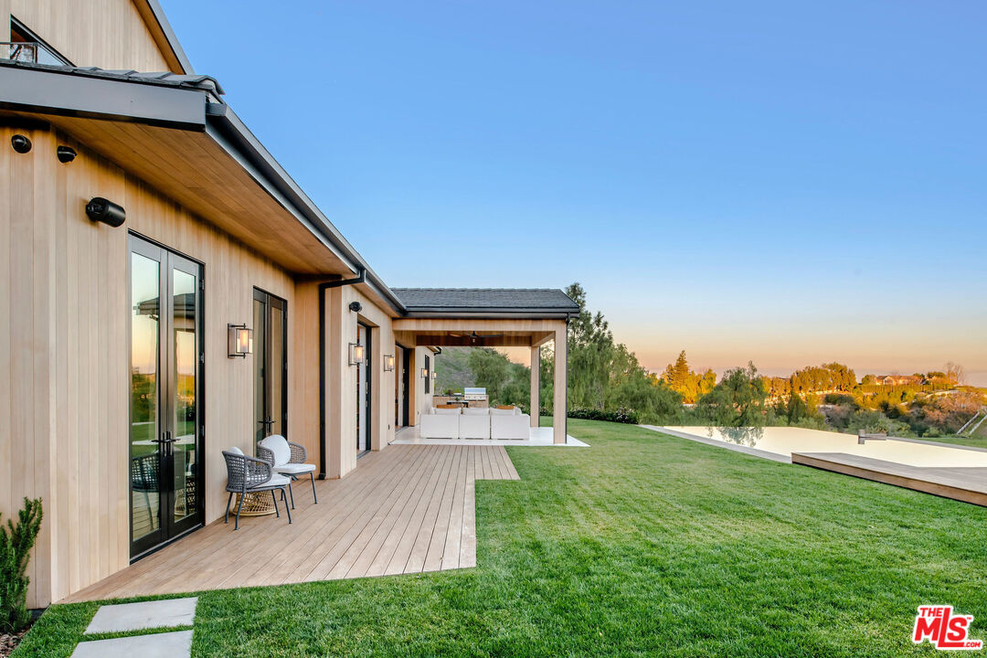 5505 Hoback Glen Road Hidden Hills, CA 91302 - Photo 40 of 43 a view of a patio with table and chairs and potted plants