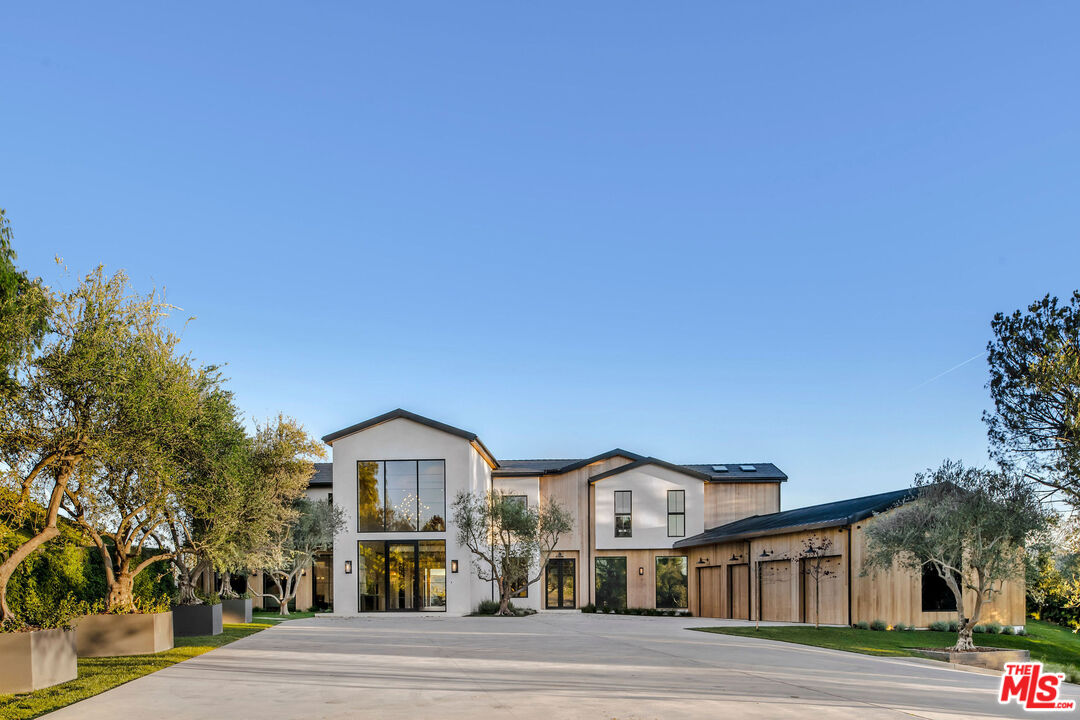 5505 Hoback Glen Road Hidden Hills, CA 91302 - Photo 4 of 43 a view of a big house with a street and plants