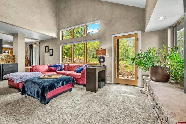 a view of a livingroom with furniture and a window