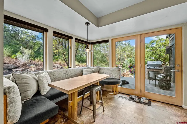a living room with furniture a rug and a book shelf