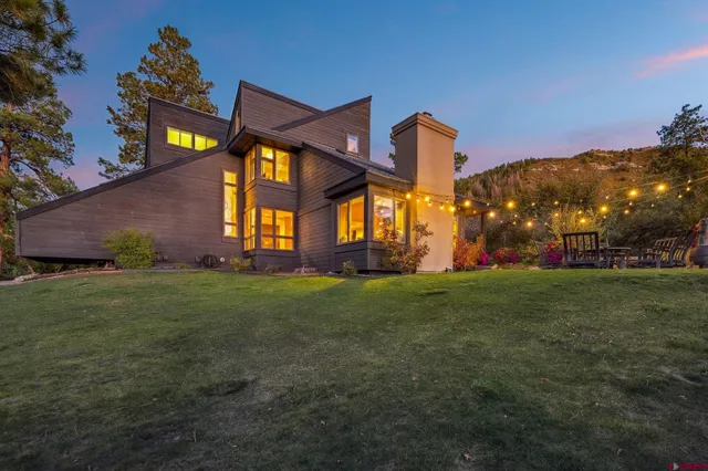 a front view of house with yard and outdoor seating