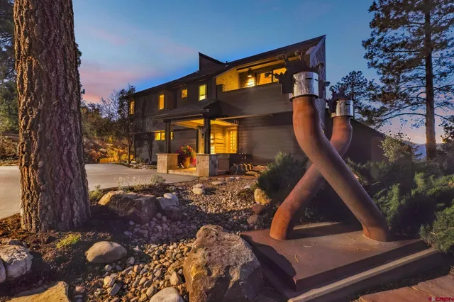 a view of a chair and table in backyard of the house